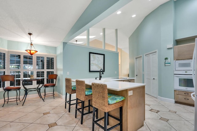 kitchen with white appliances, light tile patterned flooring, and baseboards