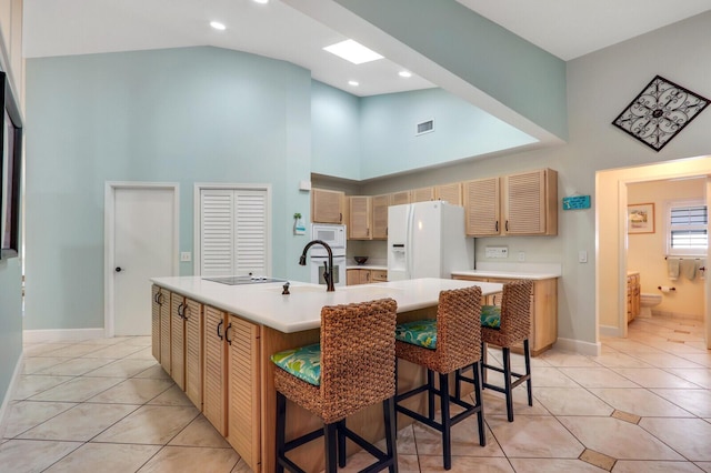 kitchen with white appliances, light countertops, and light tile patterned flooring