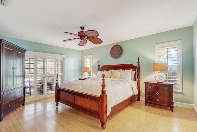 bedroom with access to outside, light wood finished floors, a ceiling fan, and baseboards