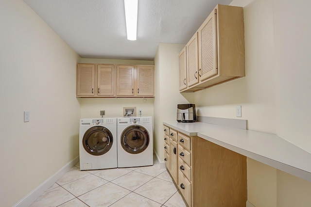 laundry area featuring cabinet space, light tile patterned flooring, a textured ceiling, separate washer and dryer, and baseboards