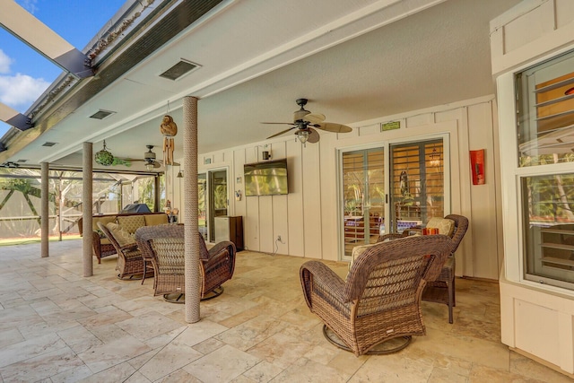 view of patio featuring a lanai, ceiling fan, fence, and visible vents