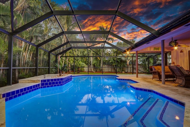 pool at dusk featuring fence, a fenced in pool, and a patio