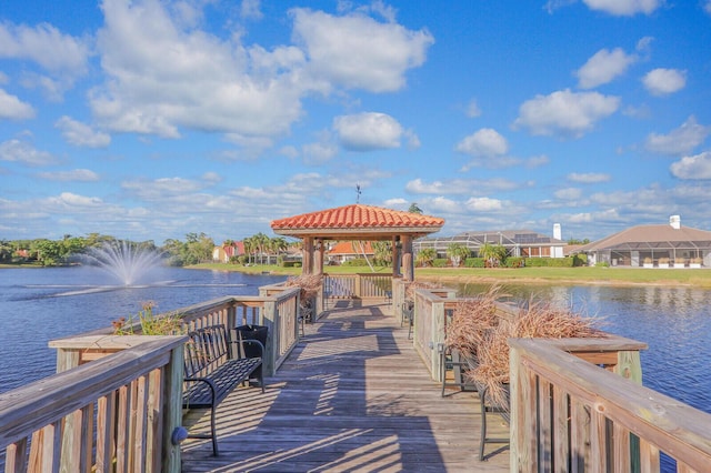 view of dock with a gazebo and a water view