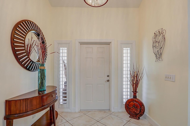 foyer with baseboards and light tile patterned flooring