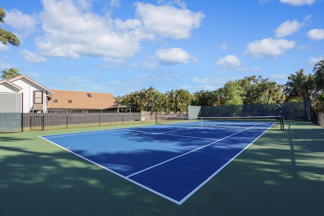 view of tennis court featuring fence