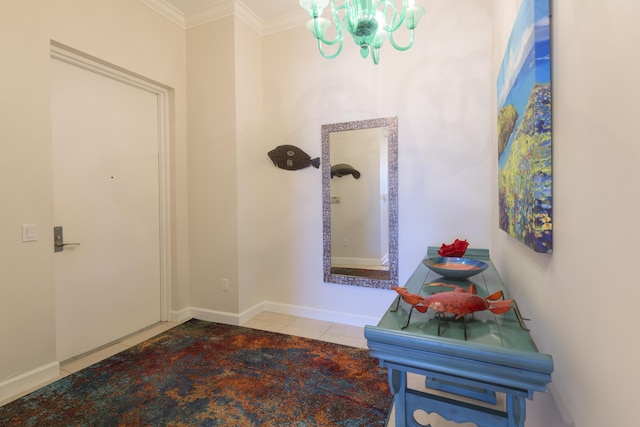 tiled foyer entrance with baseboards, ornamental molding, and an inviting chandelier