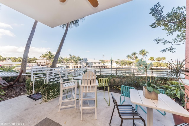 view of patio with ceiling fan and fence