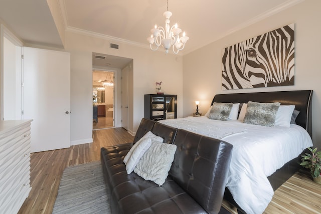 bedroom with visible vents, baseboards, ornamental molding, wood finished floors, and an inviting chandelier