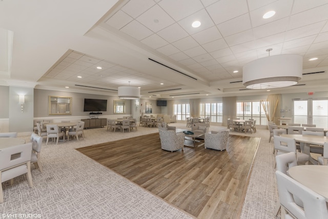 carpeted living area featuring a tray ceiling and recessed lighting