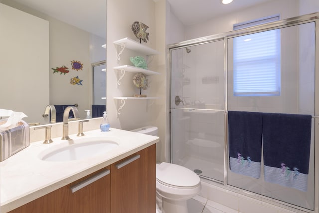 full bath with a stall shower, vanity, and toilet