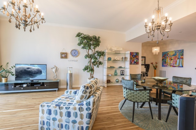 dining area with ornamental molding, wood finished floors, visible vents, and a notable chandelier