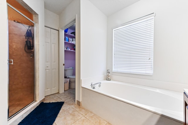 6721 Stonecreek St, Greenacres, FL 33413 - bathroom with a stall shower, tile patterned flooring, toilet, a garden tub, and a closet