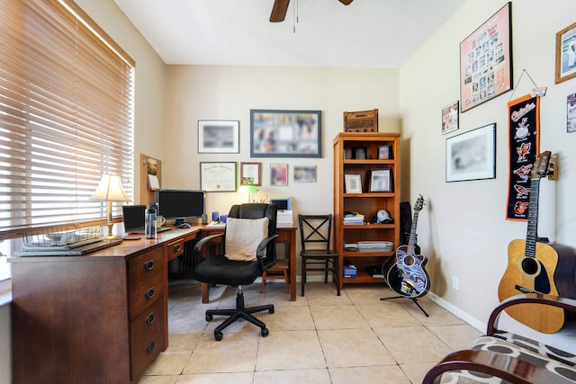 office area with light tile patterned flooring, baseboards, and ceiling fan