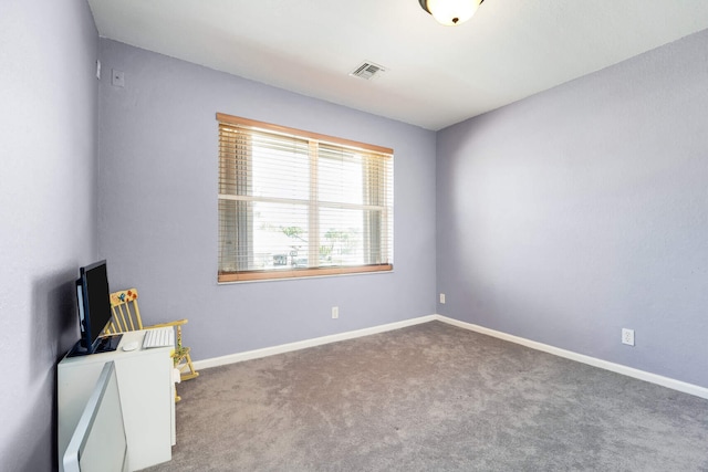 empty room featuring carpet flooring, baseboards, and visible vents