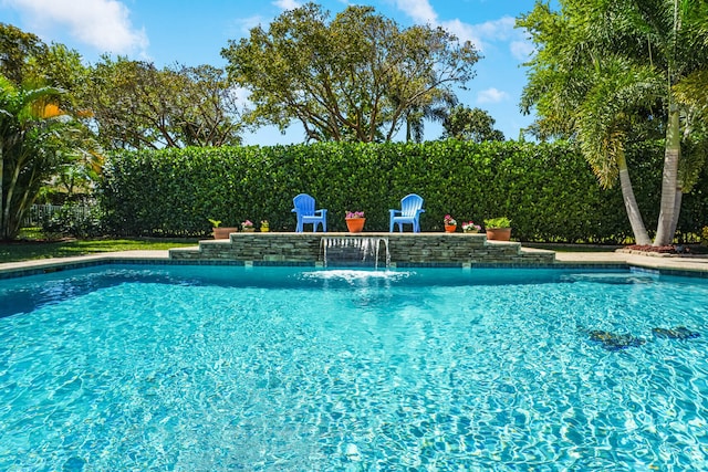 view of swimming pool with a fenced in pool and fence