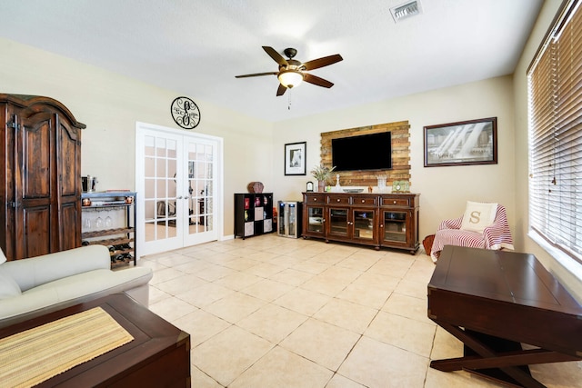 living room featuring light tile patterned flooring, visible vents, french doors, and ceiling fan