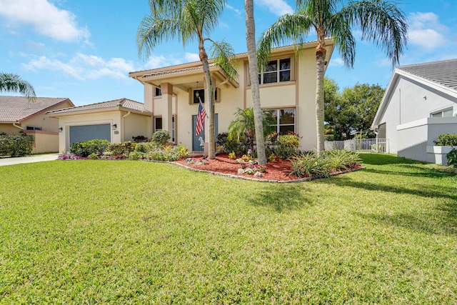 view of front facade with stucco siding, driveway, fence, a front yard, and an attached garage