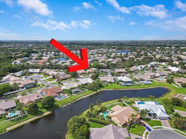 drone / aerial view with a water view and a residential view
