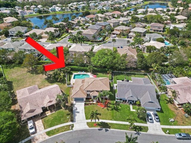 birds eye view of property featuring a residential view and a water view