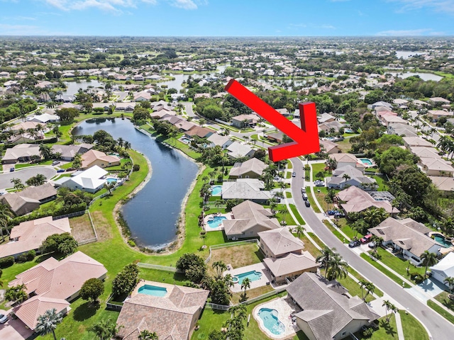 bird's eye view featuring a water view and a residential view