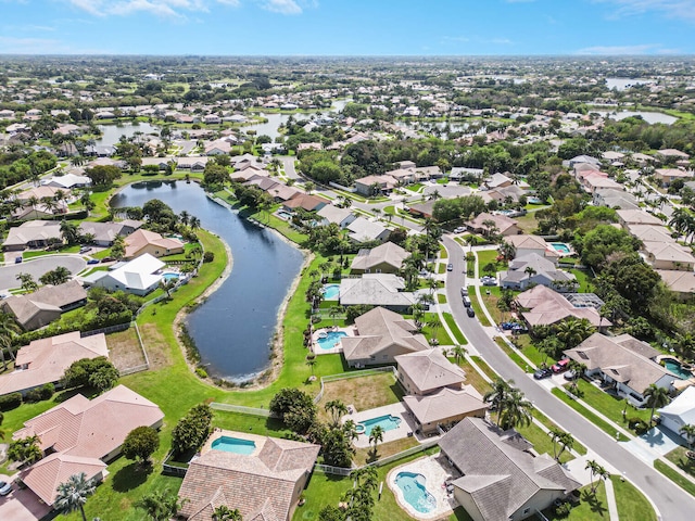 drone / aerial view featuring a residential view and a water view