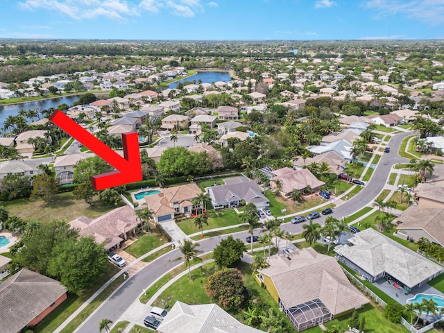 birds eye view of property with a water view and a residential view