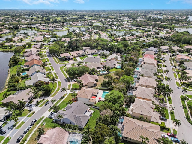 drone / aerial view with a residential view and a water view