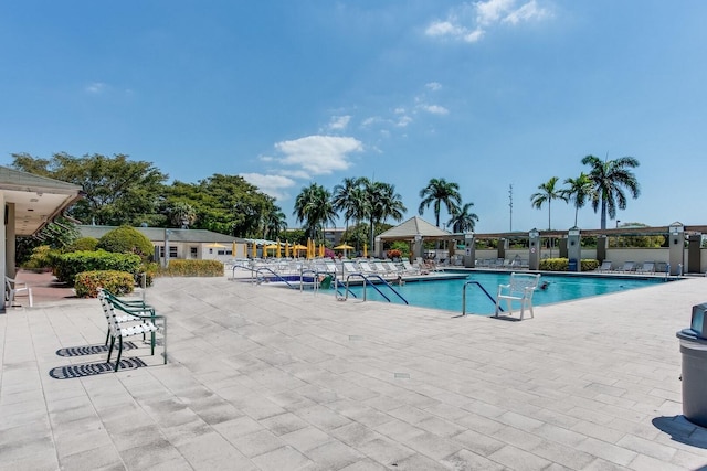 community pool with a gazebo and a patio area