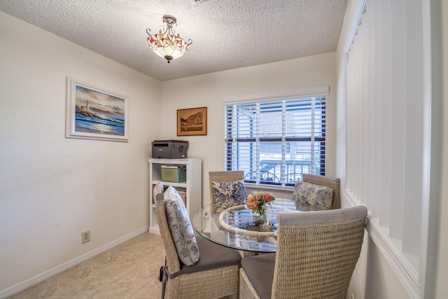 6275 SE Charleston Pl Unit B203, Hobe Sound, FL 33455 - dining area with a textured ceiling, baseboards, and tile patterned flooring