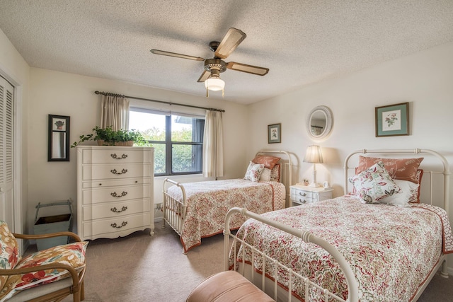 6275 SE Charleston Pl Unit B203, Hobe Sound, FL 33455 - bedroom with carpet flooring, a closet, a textured ceiling, and a ceiling fan