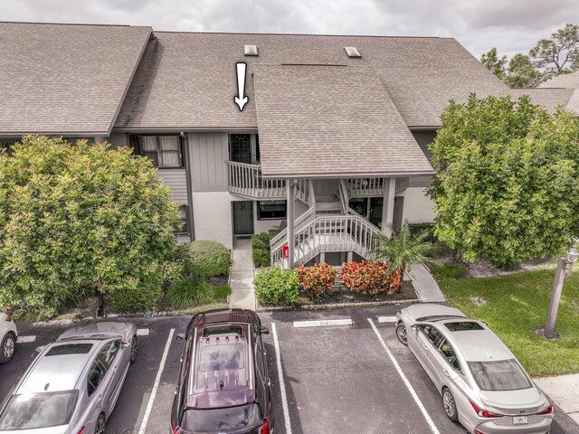 6275 SE Charleston Pl Unit B203, Hobe Sound, FL 33455 - view of property featuring uncovered parking and stairs