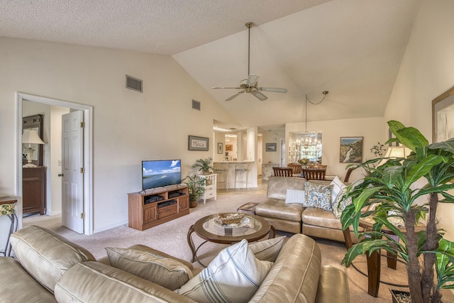 6275 SE Charleston Pl Unit B203, Hobe Sound, FL 33455 - carpeted living area with a ceiling fan, a chandelier, high vaulted ceiling, and baseboards