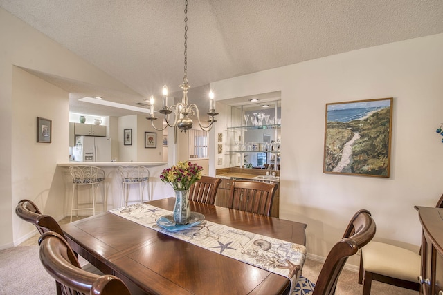 6275 SE Charleston Pl Unit B203, Hobe Sound, FL 33455 - dining area featuring carpet floors, a chandelier, baseboards, vaulted ceiling, and a textured ceiling