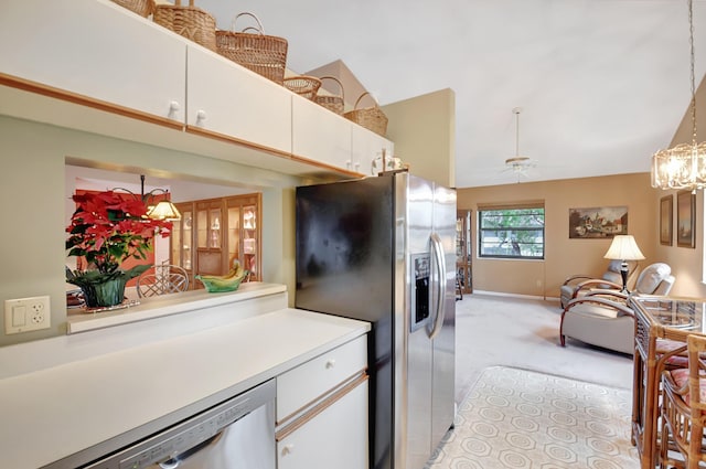 kitchen with light countertops, appliances with stainless steel finishes, decorative light fixtures, and white cabinets