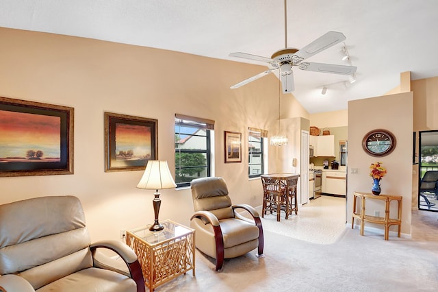 sitting room with vaulted ceiling, ceiling fan, baseboards, and track lighting