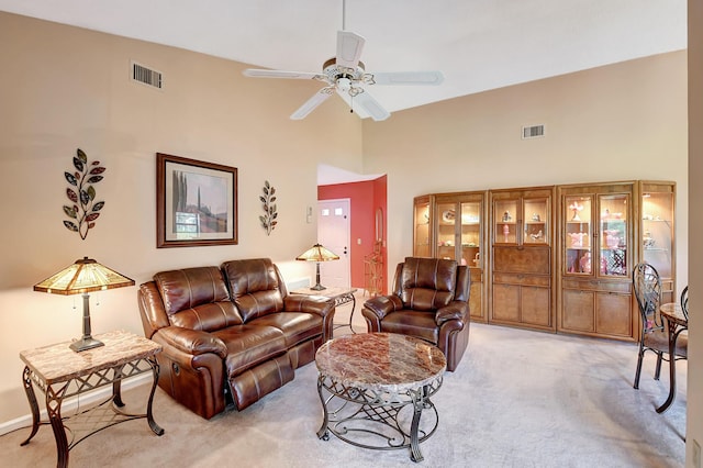 living room with light carpet, ceiling fan, high vaulted ceiling, and visible vents