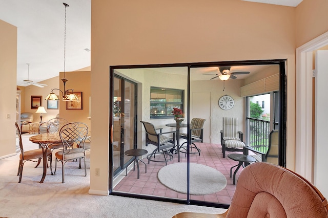 interior space featuring ceiling fan with notable chandelier