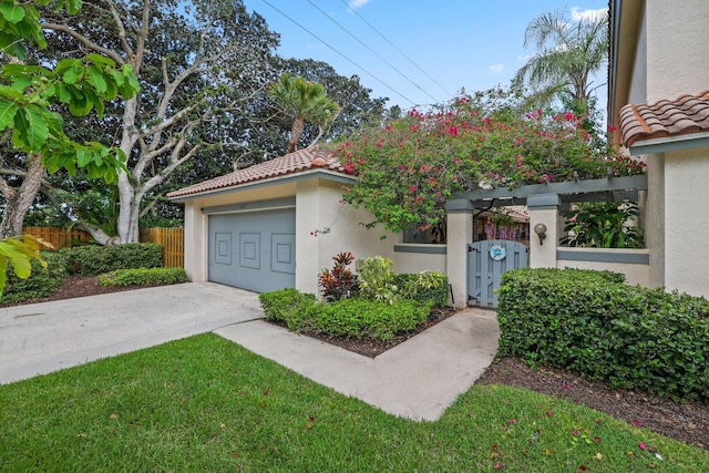 exterior space with fence, a tiled roof, concrete driveway, a gate, and stucco siding