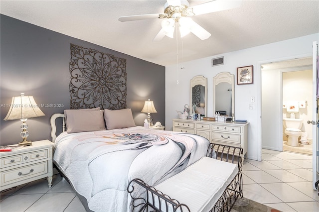 bedroom with ceiling fan, a textured ceiling, light tile patterned flooring, connected bathroom, and visible vents