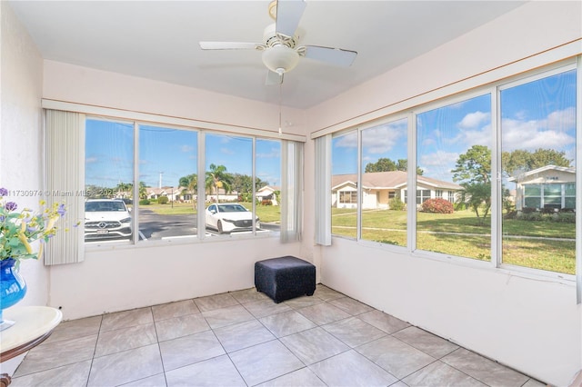 unfurnished sunroom with a ceiling fan