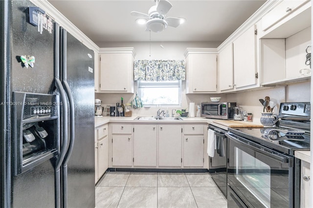 kitchen with light tile patterned floors, ceiling fan, light countertops, black appliances, and a sink