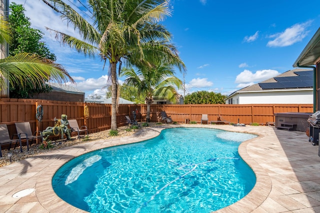 view of swimming pool featuring a patio, a fenced backyard, a fenced in pool, and a hot tub