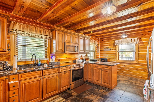 kitchen with wooden ceiling, appliances with stainless steel finishes, beamed ceiling, a peninsula, and a sink