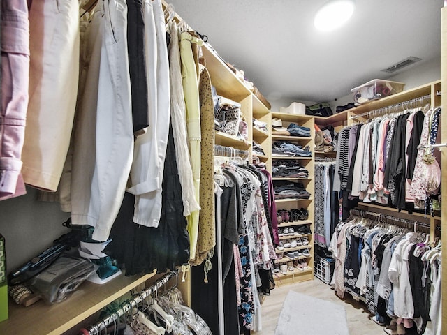 walk in closet with visible vents and wood finished floors