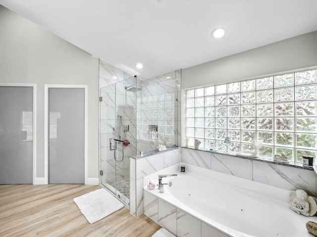 full bathroom featuring recessed lighting, a tub with jets, a shower stall, and wood finished floors