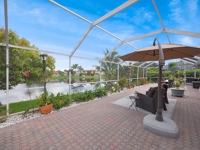 view of patio / terrace featuring a water view and a lanai