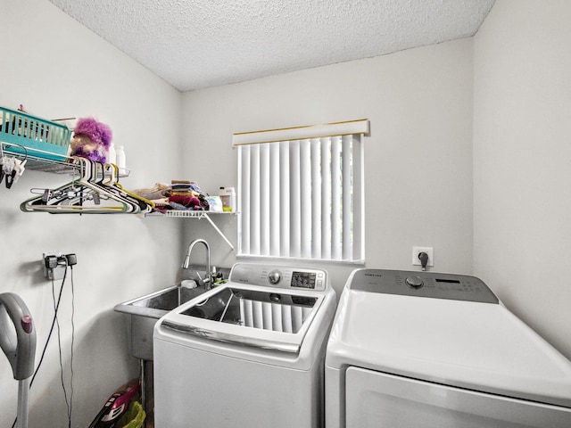 laundry area featuring laundry area, independent washer and dryer, and a textured ceiling