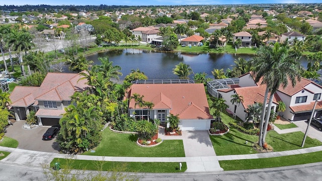 drone / aerial view featuring a residential view and a water view