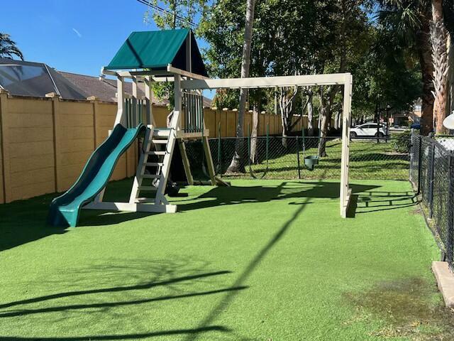 communal playground featuring fence