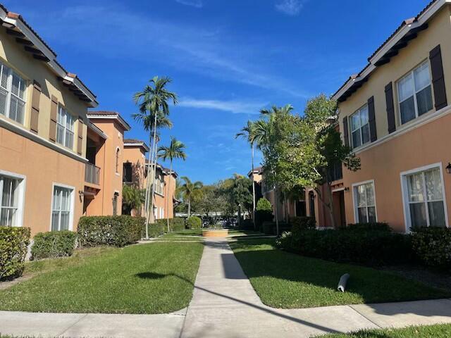 view of home's community with a residential view and a lawn